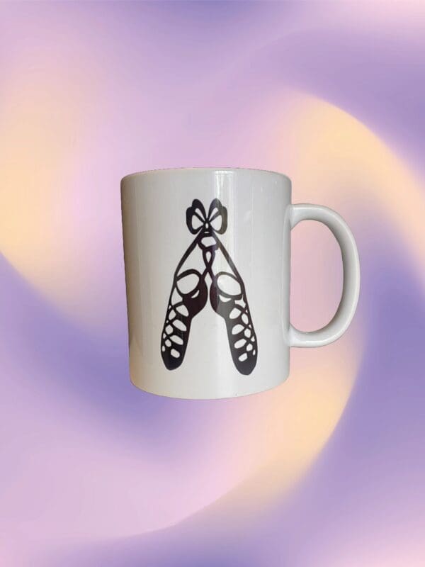 A white coffee mug with a butterfly design on it.