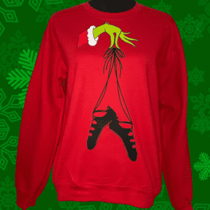 A red sweatshirt with a grinch hanging from the bottom of it.