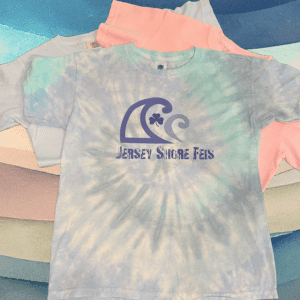 A group of different colored shirts with the jersey shore fest logo on them.