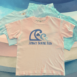 A group of different colored shirts on top of each other.